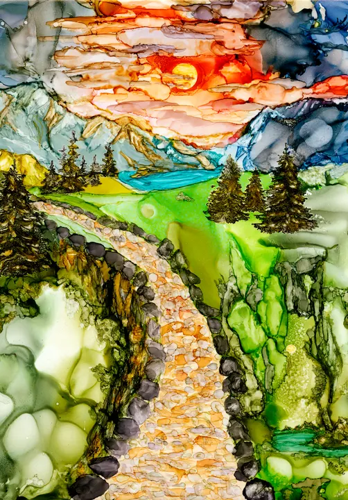 A cobbled path winding through green meadows and pines toward mountains under a fiery sunset